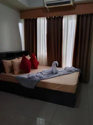 a bed in a room with a large window at 349-1br 1bed quenn 1sofa bed 2extra mattress moa view with balcony in Manila