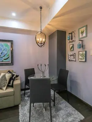 a living room with a table and chairs and a couch at BGC Urban Studio Prime Spot, Walk to Everything in Manila