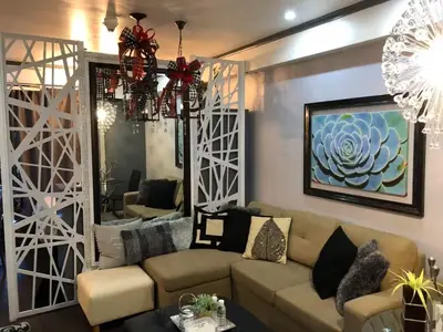 a living room with a couch and a mirror at BGC Urban Studio Prime Spot, Walk to Everything in Manila