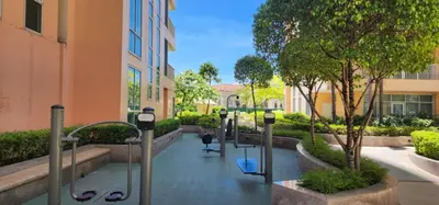 a walkway with benches and parking meters in a building at The Venice Luxury Residences Condominium 28B Bellini, McKinley Hill, Taguig City, Philippines in Manila