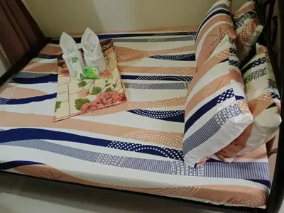 a baby crib with a bedsheet and pillows at Sea Residence Tower by let's Bareds in Manila