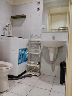 a bathroom with a sink and a toilet at Sea Residence Tower by let's Bareds in Manila
