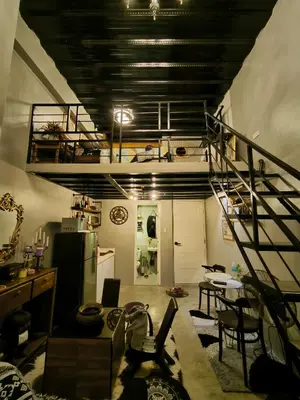 a living room with a spiral staircase in a room at Unit 820 Zamora sky tower in Manila
