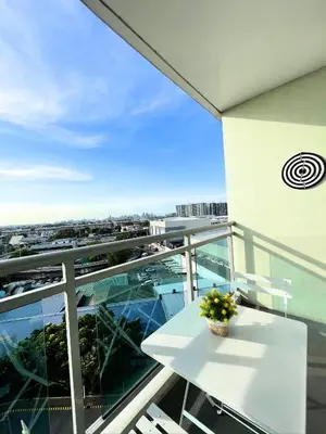 a white table on a balcony with a view of a city at SM Bicutan Condotels by Sibs in Manila