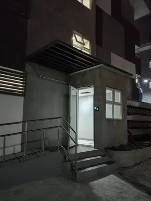 a building with a door and stairs in the night at Tanza Cavite Staycation Condo Loft in Tanza