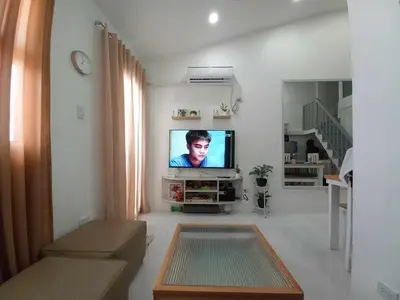 a living room with a flat screen tv on a wall at Tanza Cavite Staycation Condo Loft in Tanza