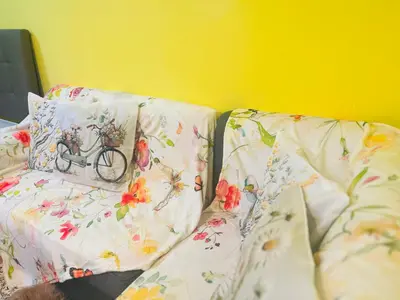 a couch with pillows with a bike on it at The Cozy Palette Manila in Manila
