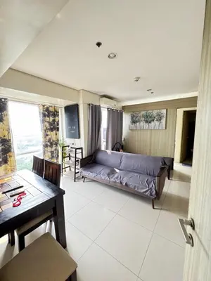 a living room with a couch and a table at Breeze Deluxe Unit Roxas blvd in Manila
