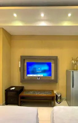a room with a flat screen tv on a wall at Mall of Asia Staycation in Manila