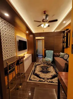a living room with a couch and a table at Casa Mexico at Air Residences Makati in Manila