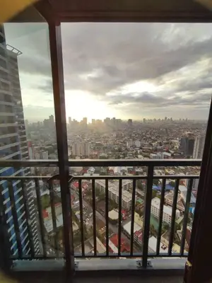 a view of a city from a balcony at Casa Mexico at Air Residences Makati in Manila