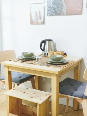 a wooden table with two bowls on top of it at The Crash Pad Soho Central in Manila