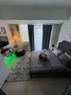 a bedroom with a large bed and a large window at SM Bicutan Azure Flat in Manila