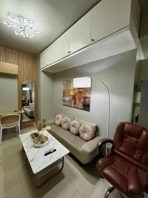 a living room with a couch and a table at 2 Bedroom Unit at Central Makati in Manila