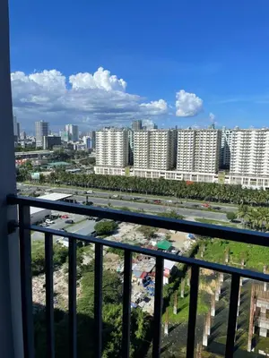 a view of a city from a balcony at The Ren Suite Facing Sunrise or City View in Manila