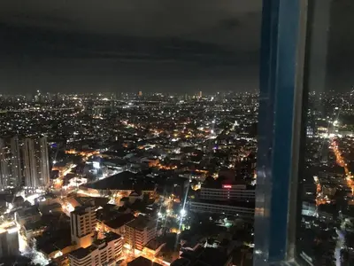 a view of a city at night with lights at Corner 1Bedroom with Unparalleled Views #5235 in Manila