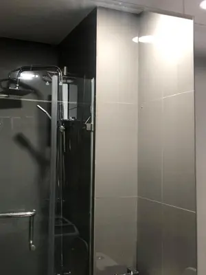 a shower stall with a glass door in a bathroom at Corner 1Bedroom with Unparalleled Views #5235 in Manila