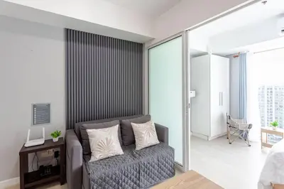 a living room with a couch in a room at Cee Staycation in the City - Azure Maui Penthouse in Manila