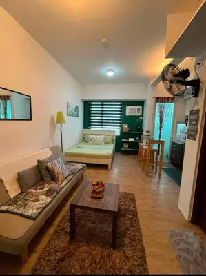 a living room with a couch and a table at Anuva Condo Staycation in Manila
