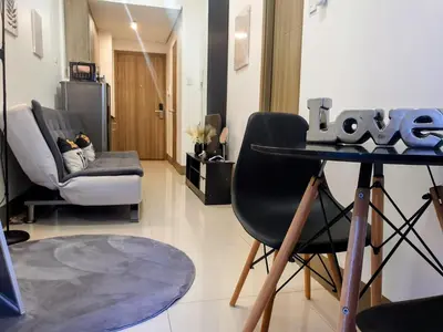 a living room with a table and two chairs at Condo with Mall in Manila