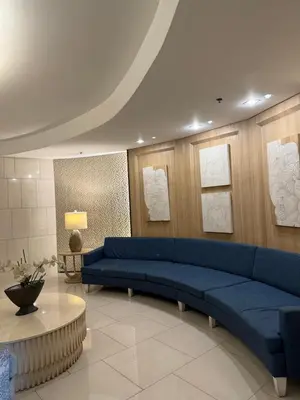 a living room with a blue couch and a table at Zeth's Place at Shell Residences Near MOA and NAIA in Manila