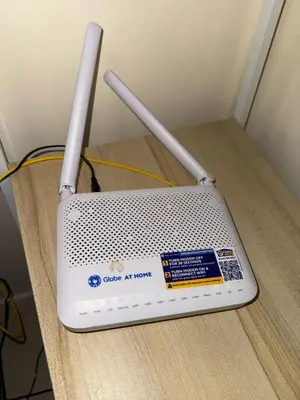 a modem sitting on top of a wooden table at FamBnb in Manila
