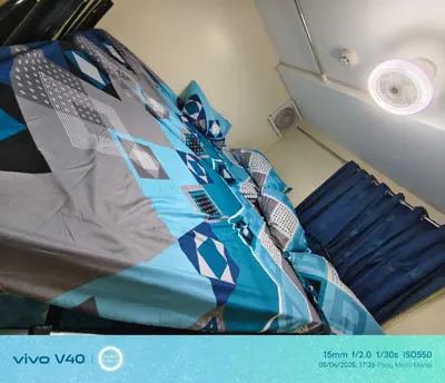a bed in the corner of a room at FamBnb in Manila