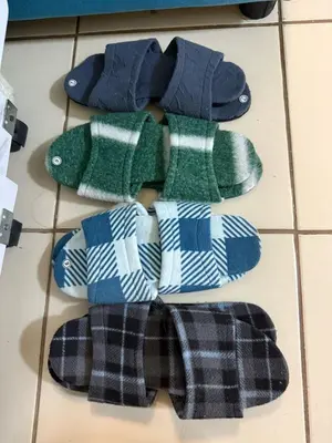 four pairs of socks sitting on a tiled floor at FamBnb in Manila