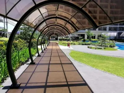 a walkway in a building with a glass roof at 2243 Taguig Condo Near Airport and BGC in Manila
