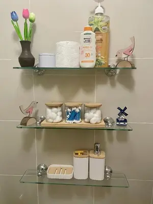 a shelf with towels and toiletries in a bathroom at Stad en Thuis - Mckinley Hill, Taguig in Manila