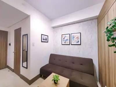 a living room with a couch and a table at 1BR Condotel with Balcony at FAME Residences #FM16-1 in Manila