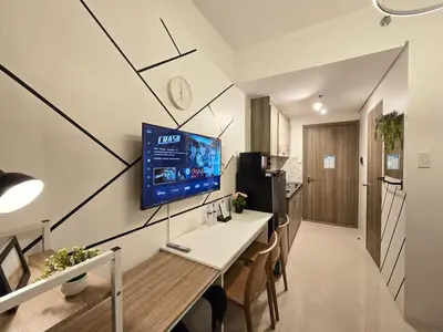 a kitchen and dining room with a tv on the wall at 1BR Condotel with Balcony at FAME Residences #FM40-1 in Manila