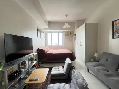 a small living room with a bed and a couch at Cozy Nook l Accessible LRT QC l Wifi & Netflix in Manila