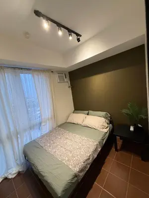 a bedroom with a bed and a window at NFr in Manila