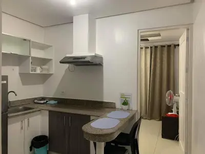 a kitchen with a counter and a sink and a counter top at Birch Tower a9 front of Robinson PlaceRizal park in Manila