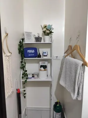 a bathroom with white shelves and towels at Pet Friendly Staycation at Pasig City in Manila