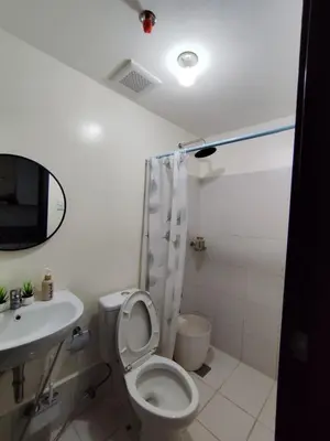 a bathroom with a toilet and a sink at Pet Friendly Staycation at Pasig City in Manila