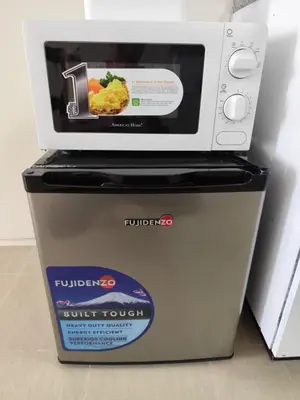 a microwave sitting on top of a trash can at Pet Friendly Staycation at Pasig City in Manila