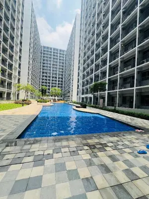 a swimming pool in a city with tall buildings at City Solace in Manila
