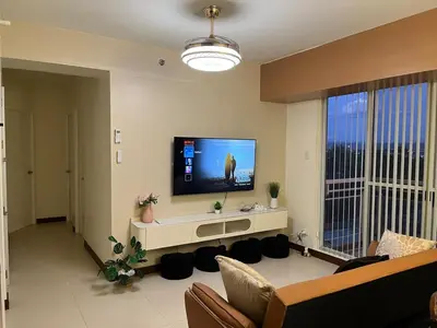 a living room with a large flat screen tv at 86 sqm, 3BR condo, Free Prking, WiFi, ntflx in Manila