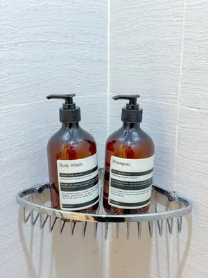 two bottles of soap are sitting on a shelf at Azure Staycation in Manila