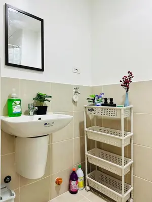 a bathroom with a sink and a toilet and a mirror at Affordable Condo Near SM Southmall in Manila