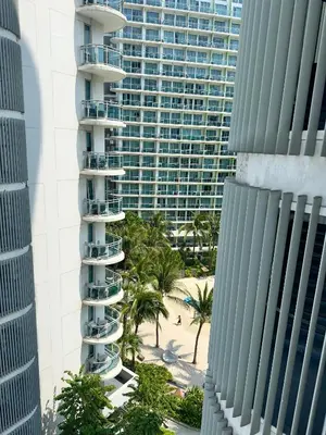 an aerial view of a tall building and a beach at Positano 933 in Manila