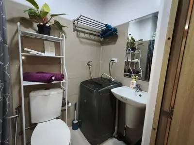 a bathroom with a toilet and a sink at Shore Residences - Cozy 1BR Apartment near MOA in Manila