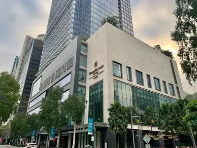 a large white building in a city with tall buildings at Avant at the Fort King bed Central 5mins to Highstreet BGC in Manila