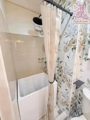 a small bathroom with a tub and a sink at Mall of Asia Casa de Lune at Shore 2 in Manila