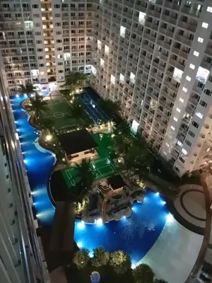 an aerial view of a tennis court in a city at night at Shore moa view in Manila