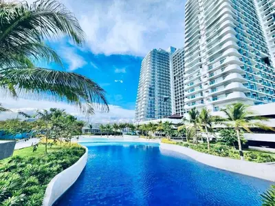 a swimming pool in front of some tall buildings at SM Bicutan Condo by Santorini in Manila