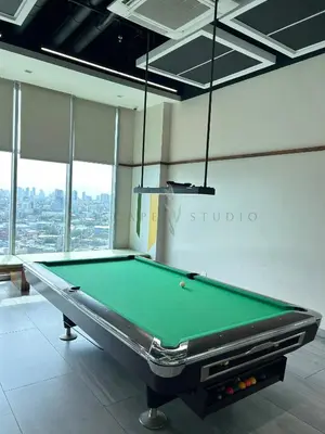 a billiard table in a room with a window at Trescape Studio in Manila