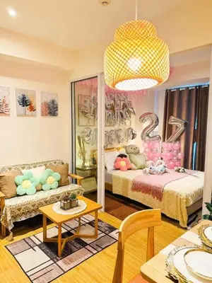 a living room with a bed and a couch at SM Condotels by Maui in Manila